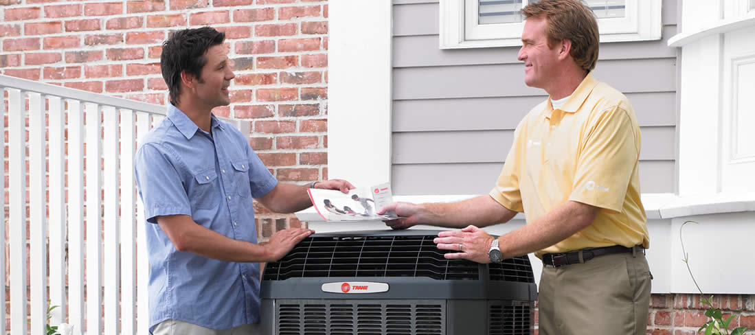 Trane salesman chatting with home owner about new ac unit